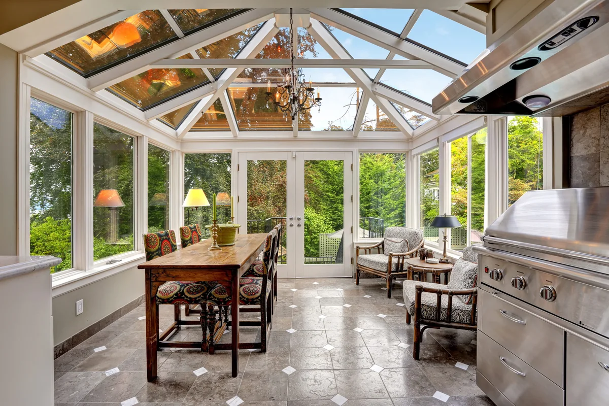 Sunroom with clear windows looking out onto a green garden